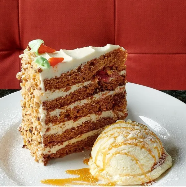 Markham dessert restaurant serving a tall slice of signature Sky-High Carrot Cake.