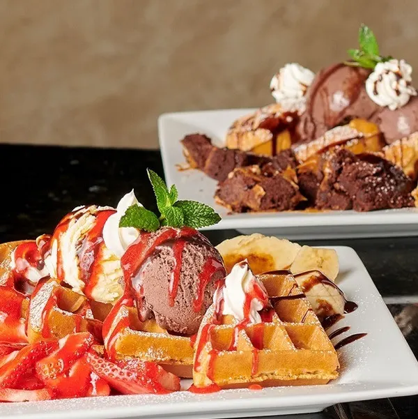 Markham dessert café serving a golden Belgian waffle topped with creamy ice cream and rich dessert sauce.
