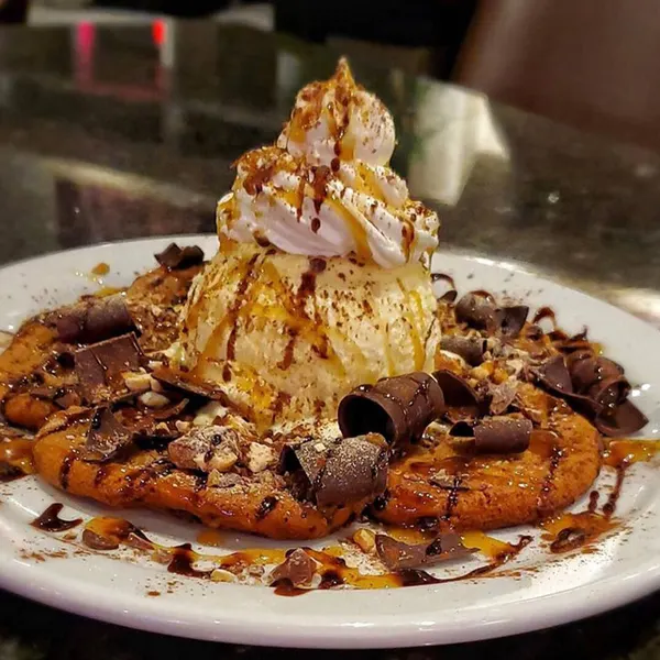 Legendary Milton pan-baked cookie topped with creamy ice cream and rich chocolate chips.