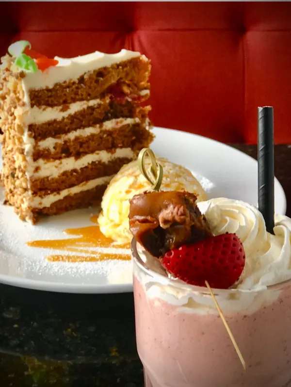 Sunday two-for-one dessert spread with carrot cake, vanilla ice cream and a creamy fruit milkshake.