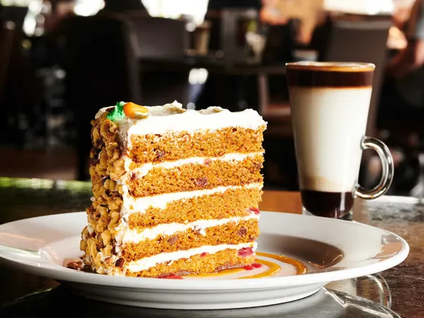 Milton signature Carrot Cake and handcrafted latte, a popular gourmet dessert pairing.