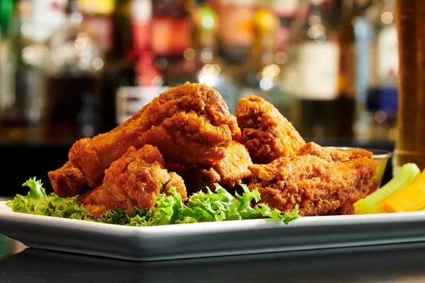 Symposium Wednesday favourite with hot crispy chicken wings tossed in bold sauce.
