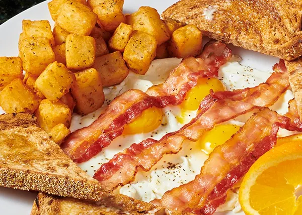 Family breakfast in Guelph with eggs, crispy bacon, golden home fries and warm toast.