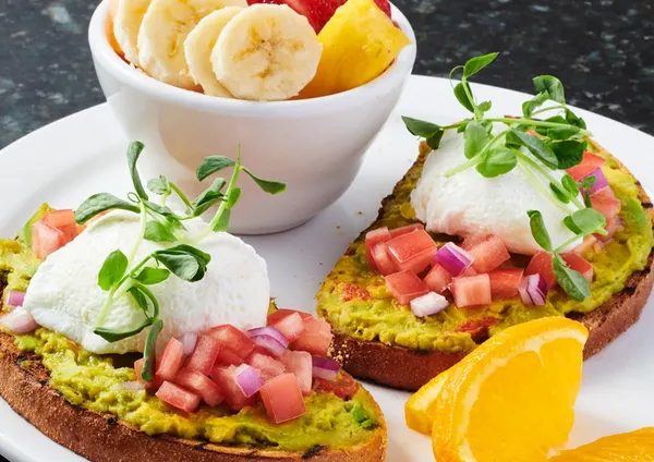 Bolton breakfast spot serving creamy avocado toast with fresh sides from the all-day breakfast menu.
