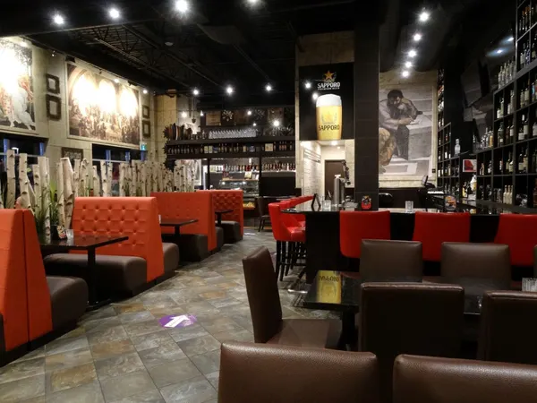 Waterloo dining room at Symposium Cafe with warm lighting, comfortable booths and an upscale-casual atmosphere.