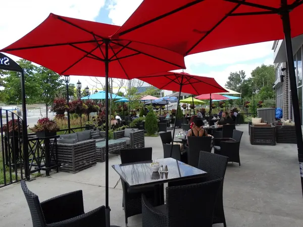 Ajax seasonal patio at Symposium Cafe with relaxed outdoor seating for brunch, dinner, desserts and cocktails.