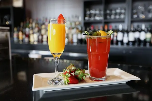 Brunch cocktails and mimosas with loaded Caesars and fruity specialty drinks at Symposium Cafe.