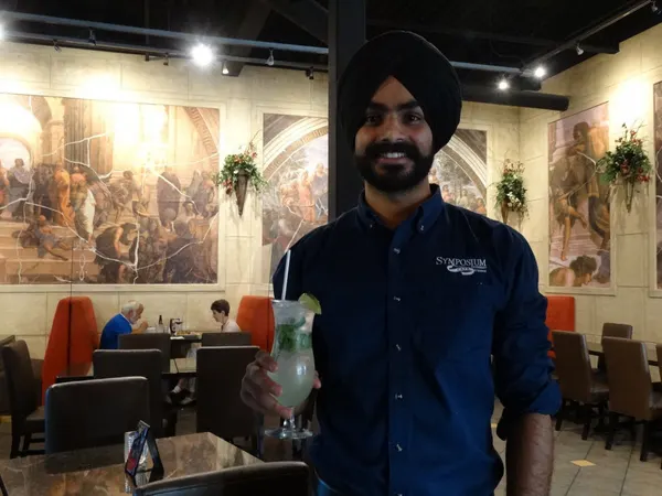 Friendly table service inside Symposium Cafe with a warm atmosphere for casual family dining.