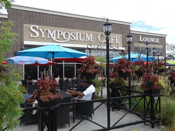 Seasonal outdoor patio at Symposium Cafe with comfortable seating for brunch, dinner and drinks.