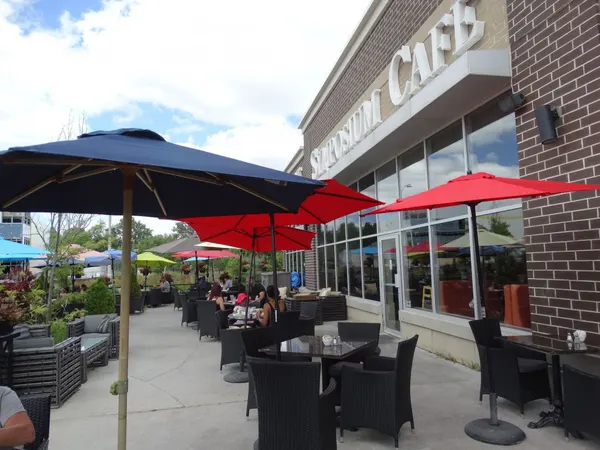 Warm and inviting Symposium Cafe patio with comfortable seating for relaxed outdoor dining.
