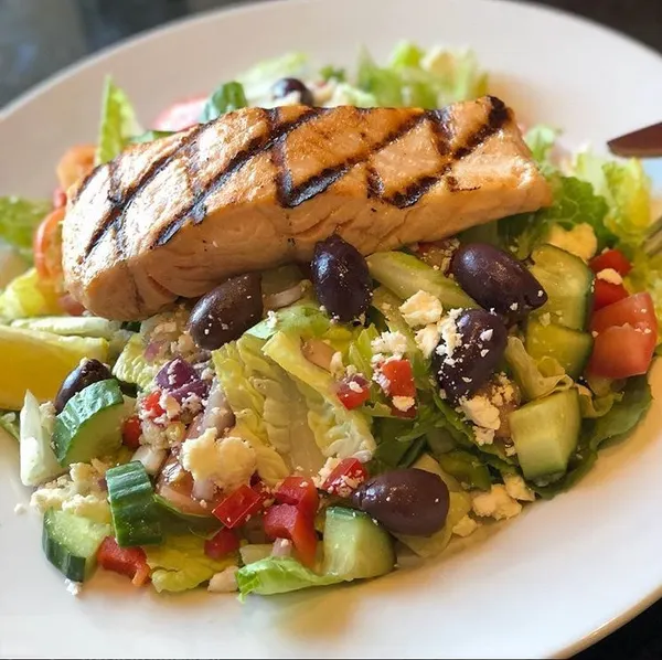 Thornhill seafood dinner featuring grilled salmon over a fresh Mediterranean salad at Symposium Cafe Restaurant