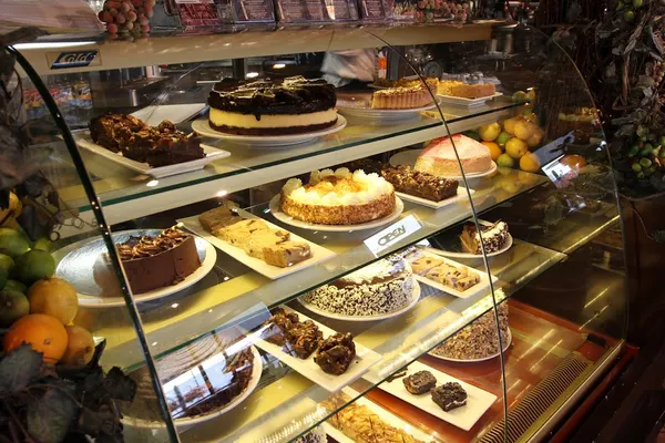 Popular dessert spot in Bolton Ontario featuring cake showcase with cheesecakes, specialty cakes, brownies and baked desserts at Symposium Cafe