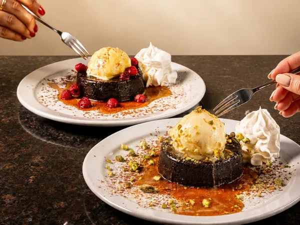 Dessert spots in Bolton Ontario serving lava cakes with ice cream, pistachios and raspberries at Symposium Cafe Restaurant