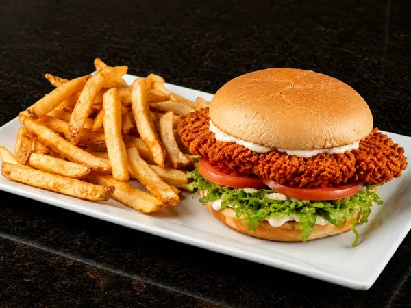 Bolton Ontario lunch spot serving Louisiana spicy chicken sandwich with lettuce, tomato and fries at Symposium Cafe