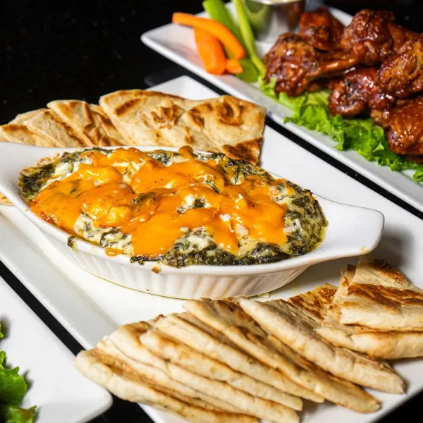 Popular appetizer spot in Bolton Ontario featuring spinach dip, pita bread and chicken wings at Symposium Cafe