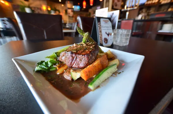 Dinner restaurant in Bolton Ontario featuring a steak entrée with seasonal vegetables at Symposium Cafe
