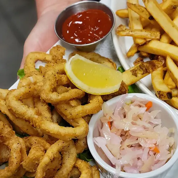 Bolton Ontario lunch restaurant serving crispy calamari appetizer with fries, coleslaw and dipping sauce at Symposium Cafe
