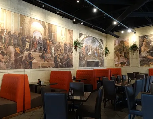 Symposium Cafe Restaurant dining room with comfortable booth seating, warm lighting and distinctive restaurant décor.
